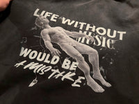 Vintage washed black streetwear hoodie with life without music would be a mistake graphic print detail and artistic figure design shown in a close-up view.