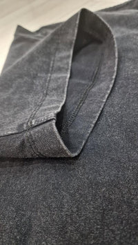 Iron Stage t-shirt in washed black streetwear style showcasing collar detail and stitching in a close-up view.