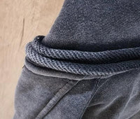 Vintage washed black streetwear hoodie with hood stitching and drawstring detail shown in a close-up view.