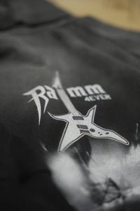 Close-up detail of a vintage washed black streetwear hoodie featuring the RAMM4EVER logo and electric guitar graphic print.