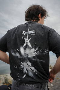 Iron Stage t-shirt in washed black streetwear style with a bold back print, worn outdoors.