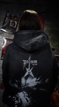 Vintage washed black streetwear hoodie with RAMM4EVER logo and electric guitar graphic worn in an indoor lifestyle setting, shown from the back.