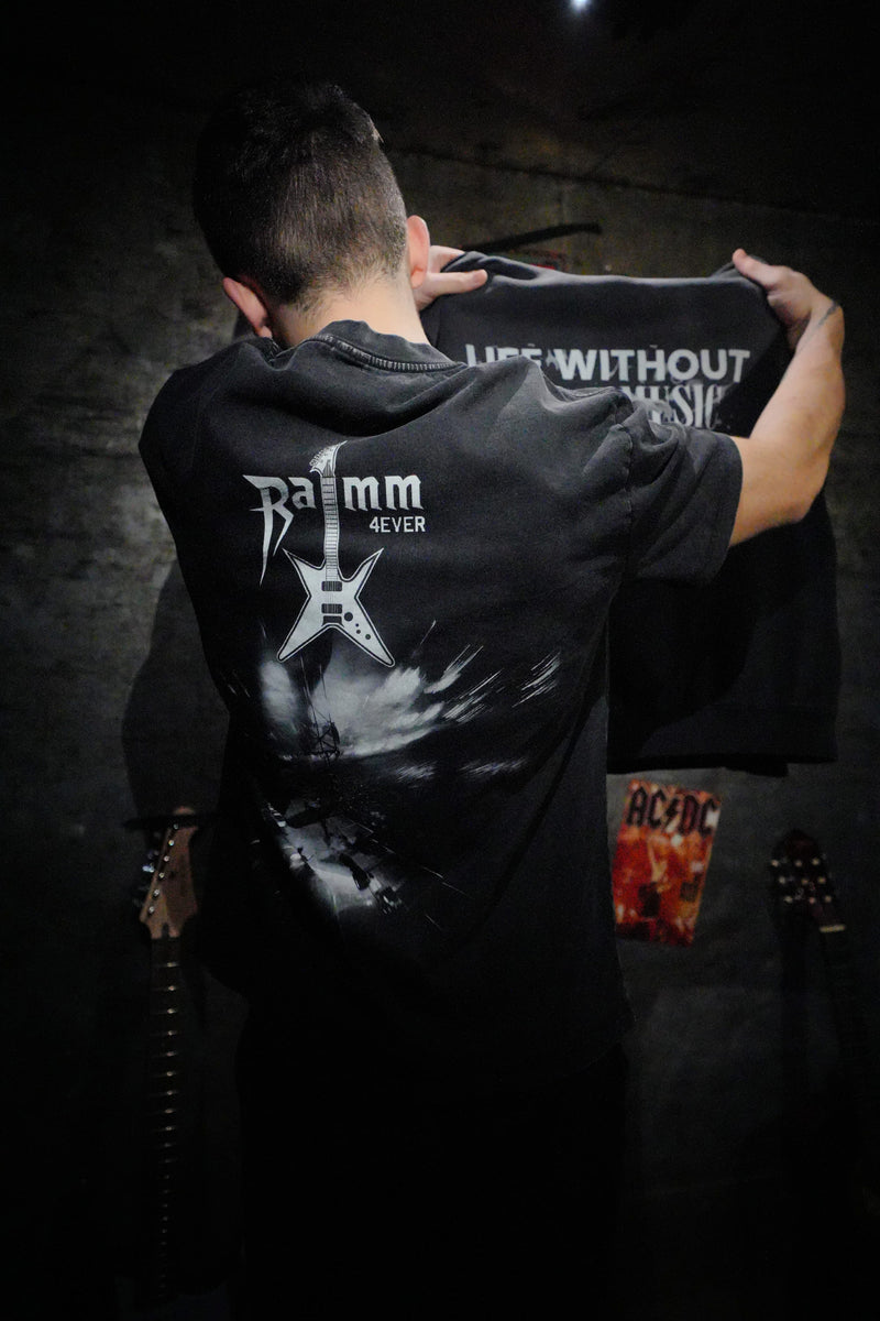 Iron Stage t-shirt in washed black streetwear style with a bold back print, worn in a studio setting.